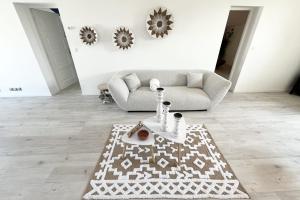 a living room with a couch and a rug at The Amantis suite XXL Bath and Sauna in Mauguio in Mauguio
