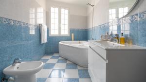 a bathroom with a tub and a sink and a toilet at Machico Village by LovelyStay in Machico +28 photos