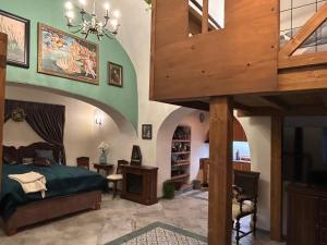 a large room with a bed and a staircase at Cisárska Komnata in Špania Dolina