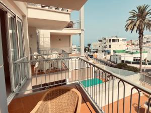 a balcony with chairs and a view of the city at Poseidon en Playa Arena in Puerto de Santiago