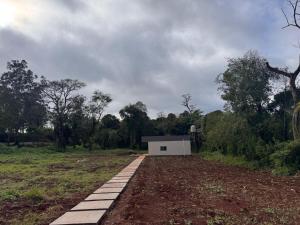 a small white building in the middle of a field at Rincon Amanay in Puerto Esperanza