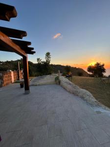 a patio with a sunset in the background at David in Cefalù