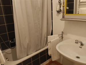 a bathroom with a sink and a shower at Appartamenti Arena in Macerata +14 photos