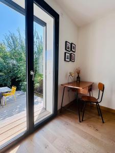 a room with a desk and a sliding glass door at Maison au calme et en ville in Meythet +22 photos