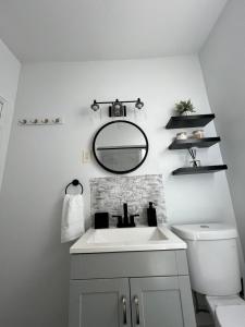 a white bathroom with a sink and a mirror at Apartamento acogedor in Jersey City +30 photos