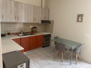 a kitchen with a sink and a table with chairs at tom house 2 in Filiatra