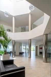 a lobby with a black couch and a plant at Hotel Atlántico in Zahara de los Atunes +78 photos