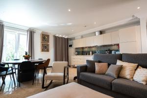 a living room and kitchen with a couch and a table at HENRI'S APARTMENTS - Pateo de Santo António in Lagos
