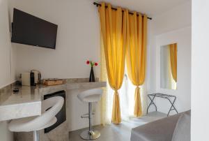 a living room with an orange curtains and a desk at Actus Palace Rooms by Ghor in Rome
