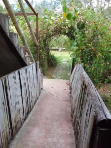 a wooden gate with a fence and a garden at Marambu Pukyu in Ibarra +4 photos