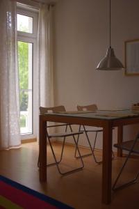 a dining room table with two chairs and a window at Ferienwohnung Bülow GM 69131 in Müritz