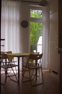 a dining room with a table and chairs and a window at Ferienwohnung Bülow GM 69131 in Müritz +6 photos