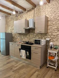 a kitchen with a stove and a microwave at Dani's House Holiday in Cagliari