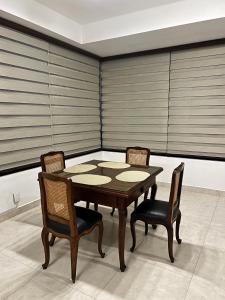a dining room with a table and two chairs at Apartamento de 2 habitaciones en el centro de Tarija! in Tarija +1 photo