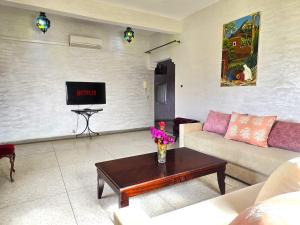 a living room with a couch and a tv at peaceful apartment in Taroudant