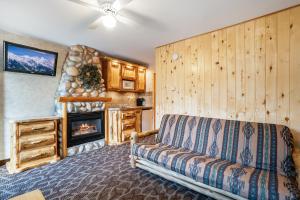 a living room with a couch and a fireplace at Spirit Lake Lodge in Grand Lake