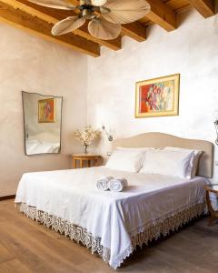 a bedroom with a bed with two towels on it at Corte Pozzol in Rivoli Veronese