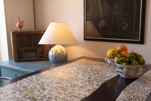 a table with a lamp and a bowl of fruit on it at Da Ida - In Lak' Ech in Matera +29 photos