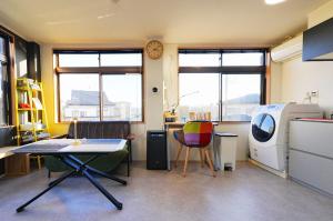 an office with a table and chairs and a washing machine at Saitama Kyodo Building - Vacation STAY 02388v in Saitama