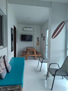 a living room with a blue couch and a table at Cabañas Ana Sofía in San Antero