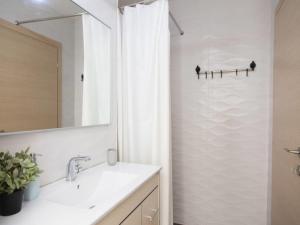a bathroom with a sink and a shower with a mirror at Alona's Apartments in Haifa +24 photos