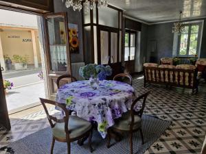 a dining room with a table with a vase of flowers on it at Ponte Fontana in Campiglia Cervo +26 photos