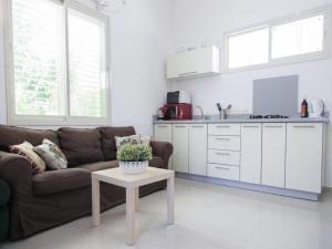 a living room with a couch and a table at Alona's Apartments in Haifa