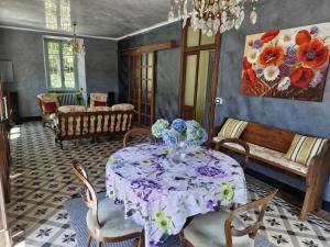 a dining room with a table with a vase of flowers on it at Ponte Fontana in Campiglia Cervo