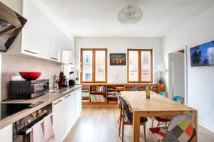 a kitchen with a table and a dining room at Two room apartment - centre historique in Mulhouse