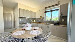a kitchen with a wooden table and chairs in a kitchen at Free Spirit Joy in Kalamata +6 photos