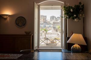 an open door with a view of a city at Da Ida - In Lak' Ech in Matera