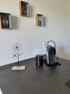 a desk with a tea kettle and a plant on it at FeWo Silence&View in Weilheim