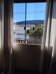 a window with a view of a building at casa da meg in Tiradentes