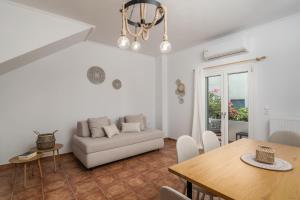a living room with a couch and a table at Aphrodite's Child Milos Maisonette in Adamantas