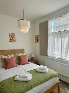 a bedroom with a bed with two towels on it at Chester City Centre Apartments in Chester