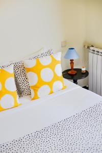 a bedroom with a bed with yellow and white pillows at Top Floor Retreat in Espinho in Espinho