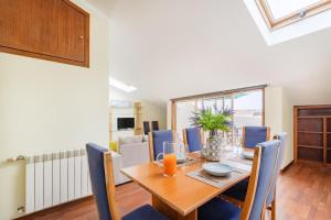 a dining room with a wooden table and chairs at Top Floor Retreat in Espinho in Espinho