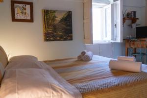 a white bed in a room with a window at Da Ida - Matera Cento Storico - Sassi in Matera