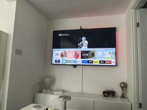 a flat screen tv hanging on a wall at Peaceful Garden Cabin Stay in the Yorkshire Wolds in Cranswick