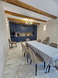 a dining room with a large table and chairs at V-House in Vama Buzăului