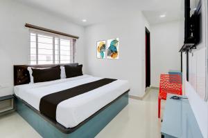 a bedroom with a large bed in a room at Hotel O Viraj Luxury Stay in Warangal