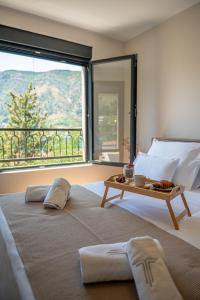 a bedroom with a large bed with a table on it at Villa Teona KotorBay Residence in Kotor
