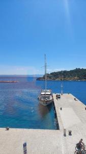 a boat is docked at a dock in the water at VELE with parking and sea view in Makarska