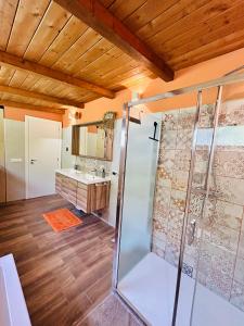 a bathroom with a shower and a wooden ceiling at Casa Tramonto in Palmi +14 photos