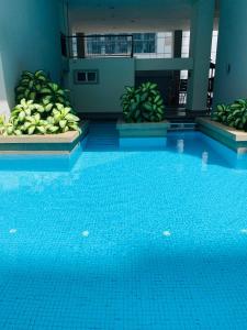 a large blue swimming pool in a building at Seri bukit ceylon residency by An homes in Kuala Lumpur