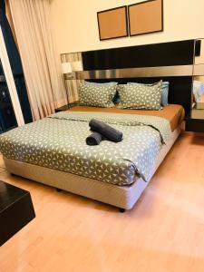 a bedroom with a bed with a remote control on it at Seri bukit ceylon residency by An homes in Kuala Lumpur