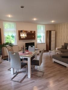 a living room with a dining table and chairs at Apartment Leucht in Ziegenrück