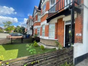 a house with a lawn in front of it at Modern Double Bedroom with Marble private bathroom in Edgware