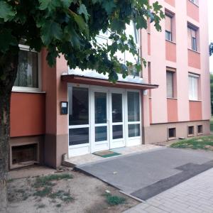 a building with a white door in front of it at Skandi Garzon in Dunaújváros