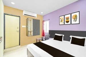 a hotel room with a bed and a window at Hotel O HOLIDAY STAR IN in Hyderabad